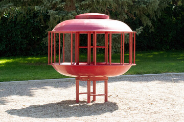 Red circular park playground climbing structure