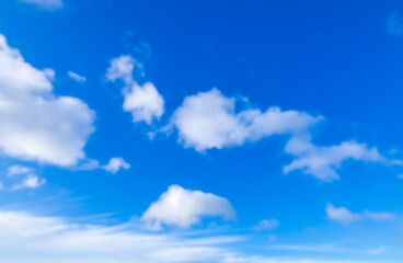 Blurred blue sky and white fluffy group of clouds background in the morning skyline