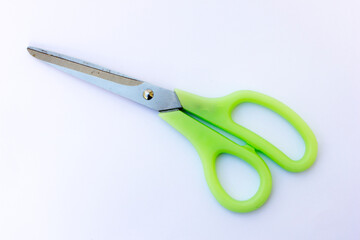 A large pair of scissors made of stainless steel. These scissors have green handles, can be used to cut paper, fabric and other items.