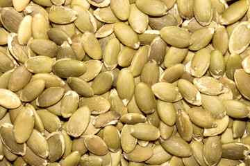 Peeled pumpkin seeds.Pumpkin seeds background.The texture of pumpkin seeds.