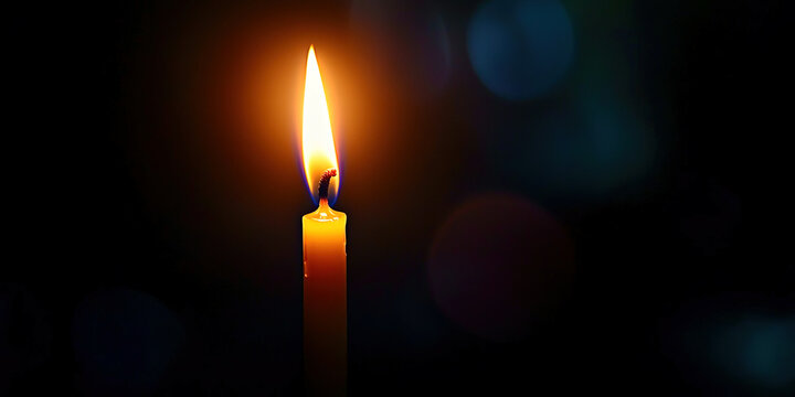 Burning candle on a black background