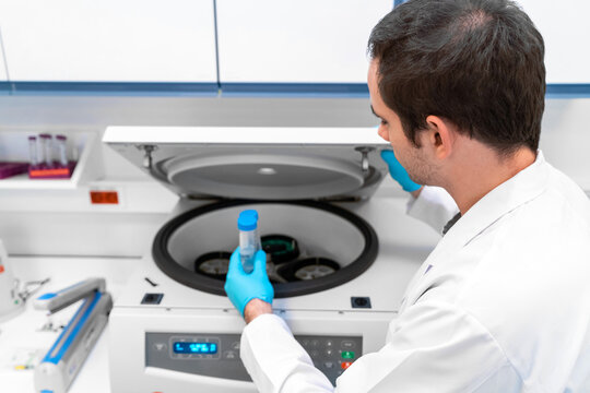 Laboratory technician using refrigerated centrifuge machine in blood bank, Benchtop Centrifuges, Device for laboratory research. Modern lab technologies. Medical Research Centrifuge. - Powered by Adobe