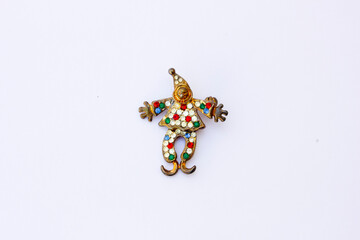 A brooch shaped like a clown. A brooch is a piece of jewelry that serves both functional and...