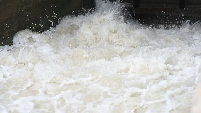 Beautiful View of water rushing Video. Indus River Head Taunsa Barrage Gates. View of water rushing through the gates at a dam. flowing and splashing water in cold river. Beautiful 4K Footage.	