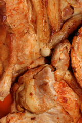 Stewed pork with a toasted crust.Stewed pork in a cast-iron dish.