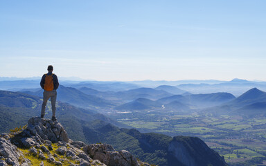 Fototapeta premium Hiker looking at the landscape. Sakana Valley from the Aralar mountain range, Navarra.