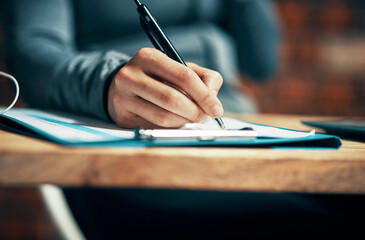 Hand, person and writing on clipboard on desk with filling application form or employment contact....