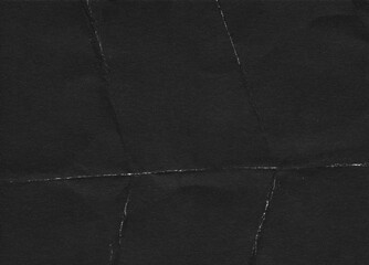 Fototapeta premium Folded paper black grunge texture with worn, rubbed and torn effect, old retro 90s texture for greeting cards, posters, web landings and other artworks