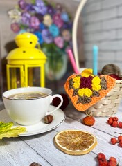 Cozy autumn photo with a cup of tea, flashlight, knitting, leaves and decor 