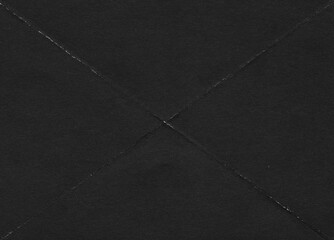 Fototapeta premium Folded paper black grunge texture with worn, rubbed and torn effect, old retro 90s texture for greeting cards, posters, web landings and other artworks