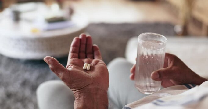 Pills, hands and senior person with water for medication for treatment of parkinsons, tremors or sickness. Healthcare, illness and patient with tablets medicine for healing in retirement home.