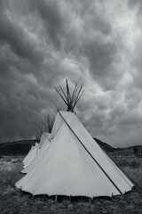 Black and White Of Moody Clouds Over Teepees © kellyvandellen