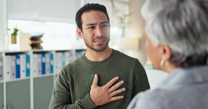 Chest pain, consultation and man by doctor in hospital for reflux, heart attack or pneumonia. Healthcare, discomfort and patient with medical worker for checkup with angina or cardiac disease.