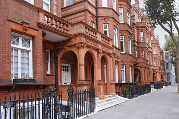 Row of older brown brick townhouses in the Sloane Square area of London