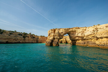 Rock formations and a natural arch on the stunning Algarve coastline, Portugal.