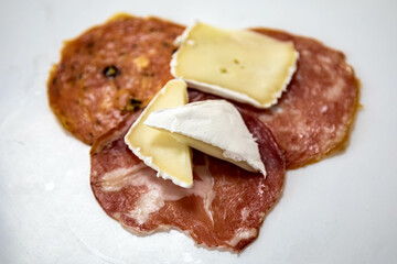 Classic appetizer with salami and camembert cheese