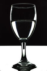 Wine Goblet portrait half filled with black water isolated, drink mockup use, studio lighting black and white screen