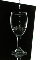 portrait of pouring refreshing water into a glass, closeup black and white photo with black frame