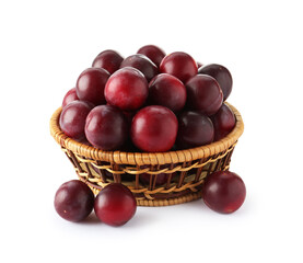 Fresh ripe plums in wicker bowl isolated on white