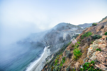 Beautiful scenery of Pacific Ocean coast along Highway 1 and Big Sur, wonderful aerial view of Bixby Bridge, sunset, sunrise, fog. Concept, travel, vacation, weekend