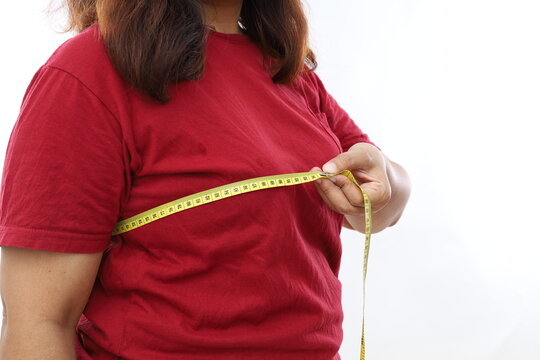 Asian woman in red shirt measuring her chest circumference. Women's breast measure concept.