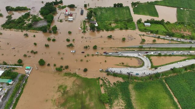 Aerial view of cars driving on the highway after road flooded during typhoon Yagi has swept Chiang Rai province of Thailand.