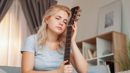 Lost muse. Upset woman. Guitar playing. Dreamful sad lady holding musical instrument feeling...