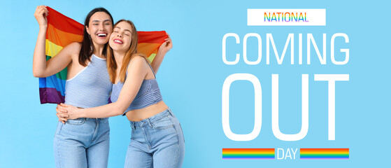 Beautiful young lesbian couple with LGBT flag on blue background