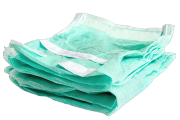 Stack of mint green surgical drapes ready for use in medical procedures, ensuring hygiene and safety for patients.
