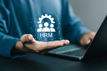 HRM, human resources management, businessman using laptop with HRM icon on virtual screen. Human development recruitment leadership and customer target concept.