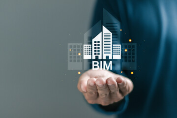 BIM, building information modeling technology concept, estate development, architecture visualization. Person holding BIM icon on virtual screen.