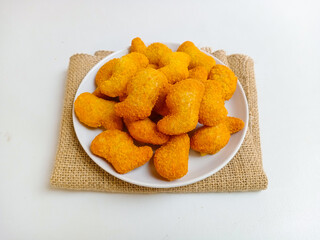 Delicious chicken nuggets in a plate, isolated white background