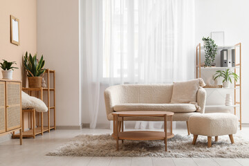 Interior of stylish living room with white sofa, armchair and wooden table