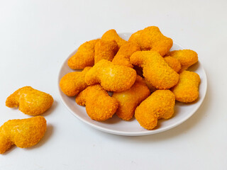 Delicious chicken nuggets in a plate, isolated white background
