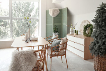 Interior of dining room with festive table setting and Christmas decorations