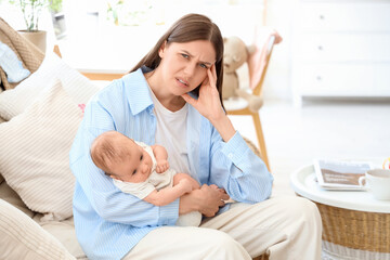 Young mother suffering from postnatal depression at home