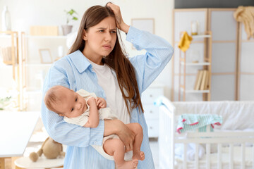 Young mother suffering from postnatal depression at home