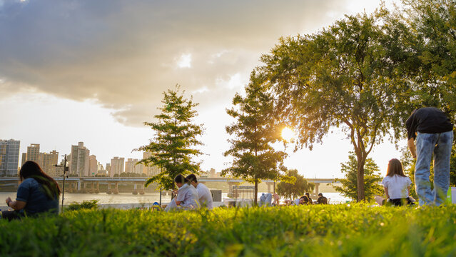 People enjoying a picnic at Hangang Park at sunset