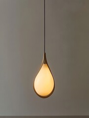 Elegant Teardrop Pendant Light Illuminating a Space, featuring a minimalist design, soft glow, natural elements, and modern aesthetics, symbolizing simplicity, warmth, harmony, elegance, and light.