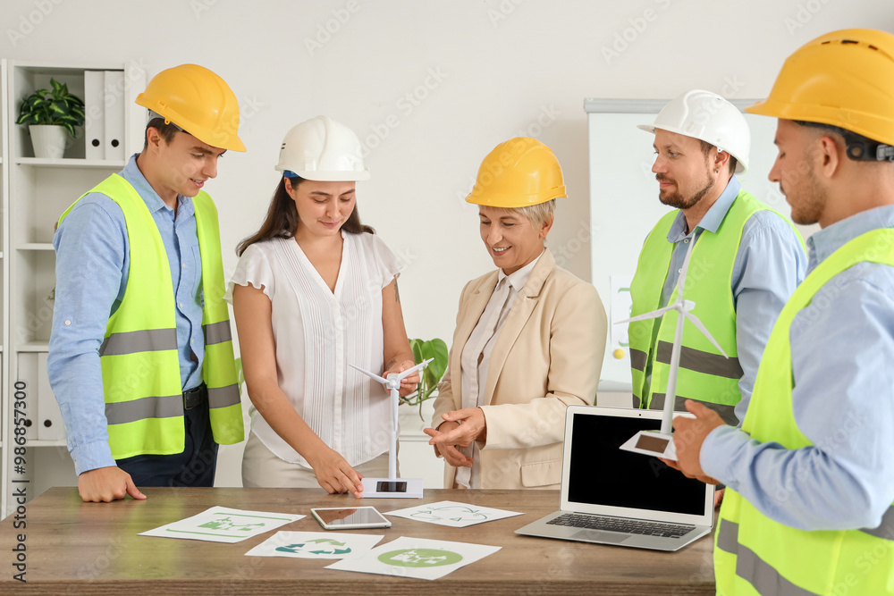 Canvas Prints Group of engineers working with wind turbine models in office