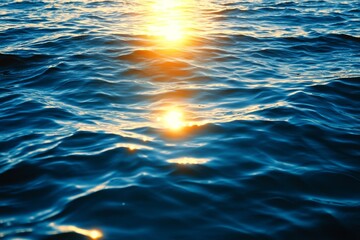 Obraz premium Sunlit Ocean Waves: A captivating image of the ocean's surface illuminated by the sun, showcasing the beauty and tranquility of nature, with shimmering reflections, rippling waves, and the warm glow o