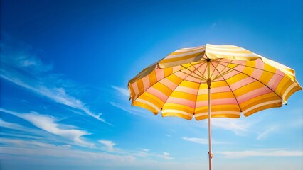 Obraz premium Yellow and Pink Striped Beach Umbrella Against Blue Sky with Clouds