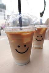 A Delightfully Cheerful Iced Coffee with Adorable Smiley Faces Decorated on the Cups