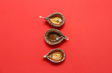 Diya lamps on red background. Divaly celebration