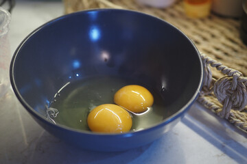 Cracking Fresh, FarmFresh Eggs into a Bowl to Prepare Delicious Meals at Home with Love