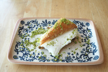 A Delicious and Mouthwatering Dessert Served on an Ornate Decorative Plate with Pistachios