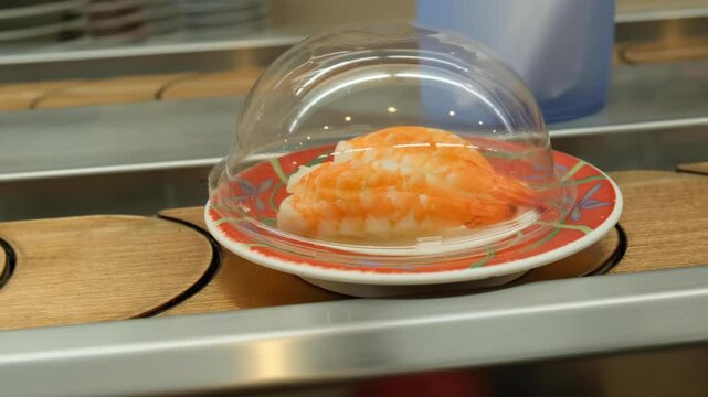 Sushi dishes riding on a conveyor belt at a Japanese restaurant.