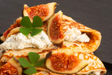 Crepes or thin pancakes with gorgonzola cheese, honey and figs fruits