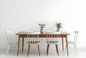A wooden dining table with four chairs, a potted plant, and a simple white wall background.