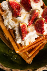 Waffles with figs, maple syrup, topped with whipped cream